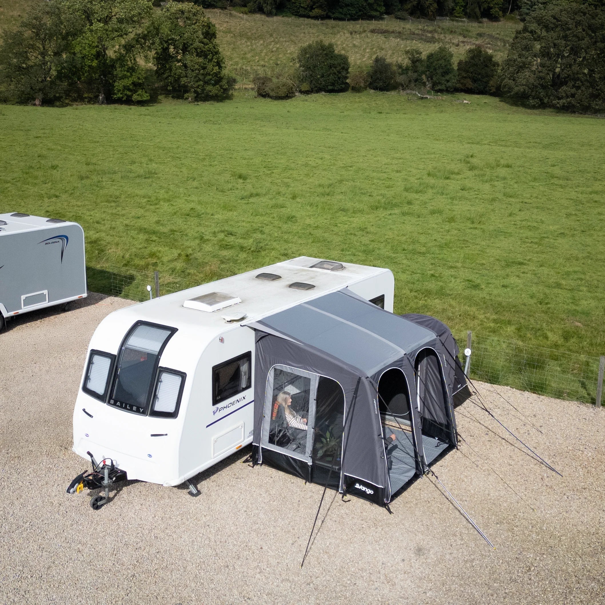 Caravan with the Vango Balletto Pro Air 260 Awning attached in a grassy field