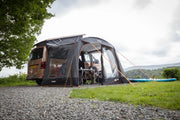 The Vango Sunlight Poled Awning/Canopy set up, attached to a van in a scenic location.