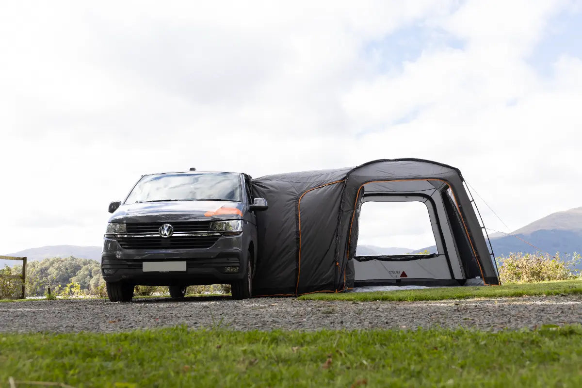 Van with Vango Tailgate Hub II Low Poled awning in a scenic outdoor setting